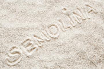 Semolina inscription on the semolina background. Healthy eating and lifestyle.