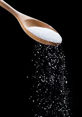 Poster Salt shaker,Sea salt on wooden spoon on black background © showcake