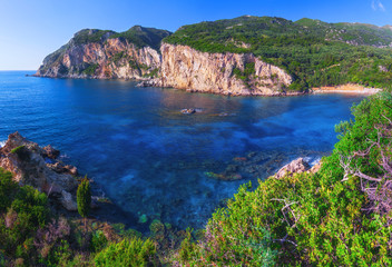 Fototapeta na wymiar Landscape of Paleokastritsa famous beach in close bay with crystal clear azure water on Corfu island, Ionian archipelago, Greece.
