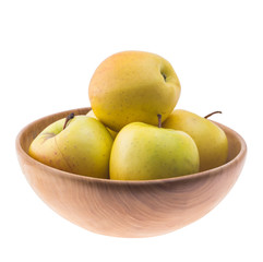 big ripe juicy yellow golden apples in wooden bowl isolated on white background