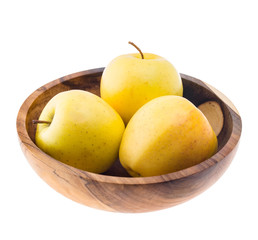 big ripe juicy yellow golden apples in wooden bowl isolated on white background