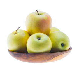 big ripe juicy yellow golden apples in wooden bowl isolated on white background
