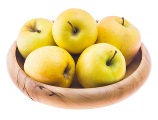 big ripe juicy yellow golden apples in wooden bowl isolated on white background