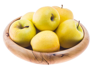 big ripe juicy yellow golden apples in wooden bowl isolated on white background