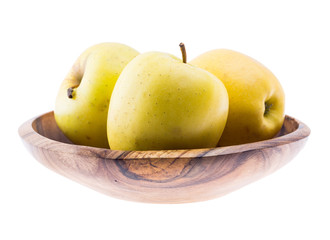 big ripe juicy yellow golden apples in wooden bowl isolated on white background