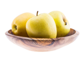 Naklejka na ściany i meble big ripe juicy yellow golden apples in wooden bowl isolated on white background