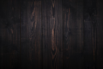 Dark brown wooden plank background.