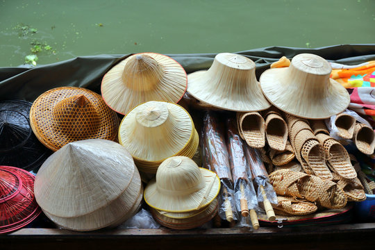 Boat with hats on floating market in Bangkok