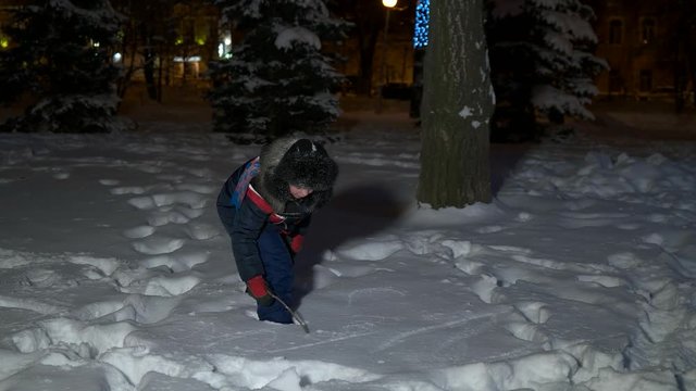boy draws on the snow