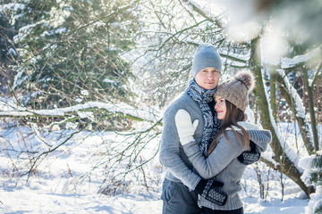 Fototapeta na wymiar Young couple in love hugs in the forest