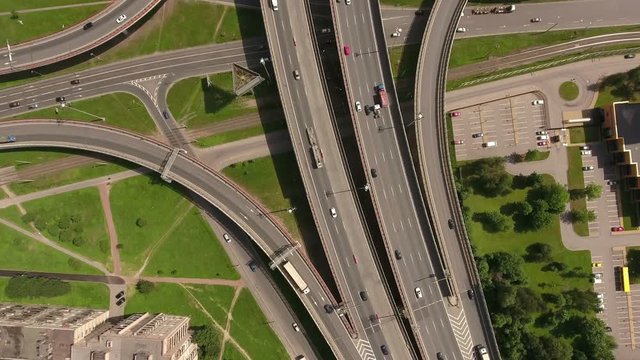 Urban interchange is near Obukhov cable-stayed bridge. Aerial view. Orbital freeway encircling city is in Rybatskoye, Nevsky district. St. Petersburg, Russia
