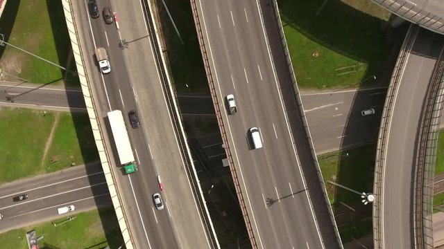 Vehicular traffic is on interchange. Aerial view. Orbital freeway encircling city is in Rybatskoye, Nevsky district. St. Peterburg
