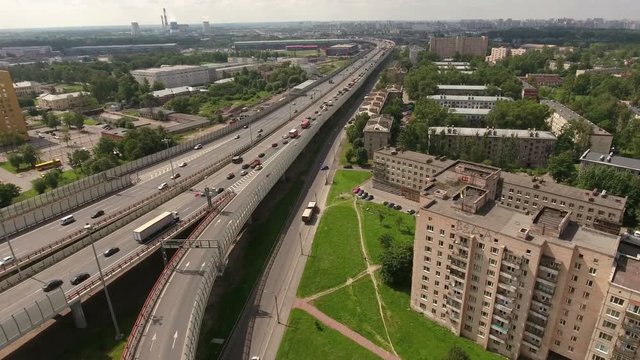City ring highway leads to south-west in the Rybatskoye municipality, Nevsky sleeping district. Aerial view. St. Petersburg, Russia
