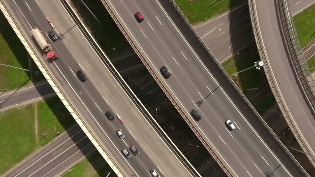 Day traffic on the St. Petersburg ring road and interchanges in summer season. Top view. Russia
