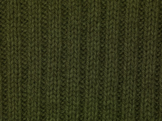 green fabric sweater close up texture background