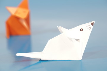 Paper origami fox and mouse are isolated on a colorful background