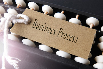 Abucas and paper tagging with business conceptual text. Lens flare added.