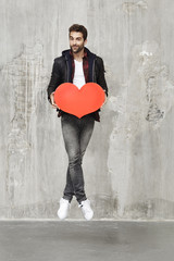 Obraz na płótnie Canvas Man jumping with Valentine heart