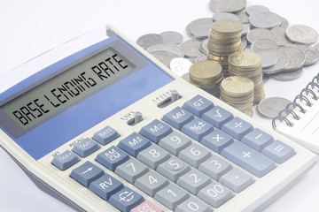 Coins and calculator with business and finance conceptual text.
