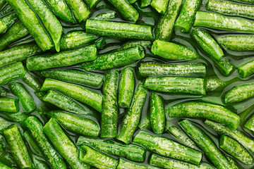 Wet fresh green french bean in water  closeup as background. Healthy vitamin food.