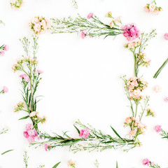Fototapeta na wymiar Wreath frame made of pink and beige wildflowers, green leaves, branches on white background. Flat lay, top view. Valentine's background