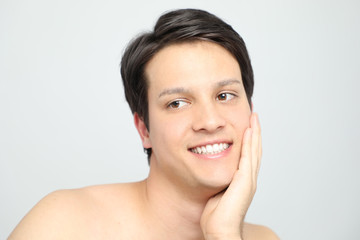 young man checking the skin of his face, men's skincare concept, acne treatment