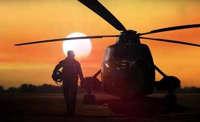 Helicopter silhouette on the ground during sunset