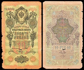 Fototapeta na wymiar Old dilapidated Russian banknote of 10 ruble in 1909. Isolated on a black background. The front and back side.