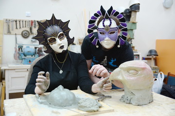 sculptors in theatrical masks