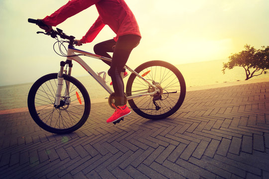 healthy lifestyle young woman riding bike on seaside