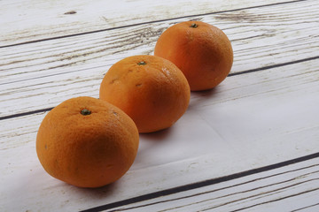 Fresh mandarin orange on a wooden background