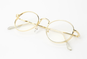 Classic gold round glasses on white background