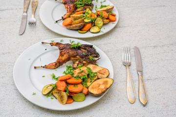 Roasted homemade quail with vegetables. Healthy food. Perfect dinner for two