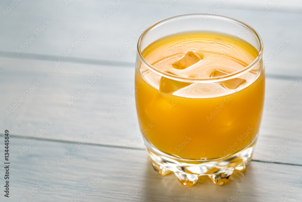 Sticker glass of mango juice on the wooden table