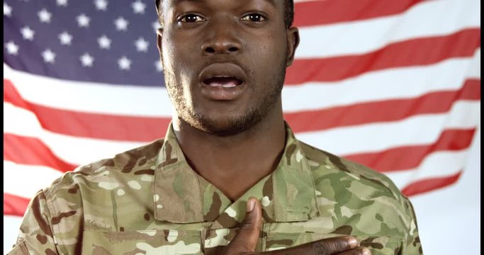 Portrait of military soldier singing a national anthem against US flag background 4k