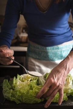 Woman salting cabbages for kimchi