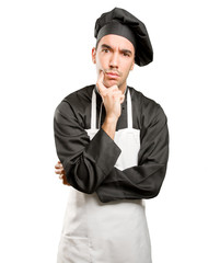 Doubtful young chef posing