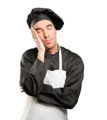 Satisfied young chef sleeping