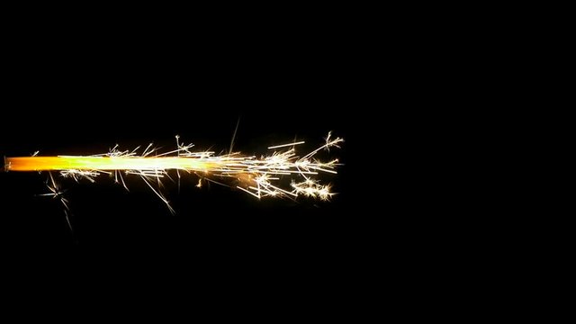 Jet of glitter and sparkles isolated on a black background in slow motion