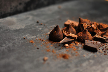 Set of chocolate, truffles and cocoa on rustic background
