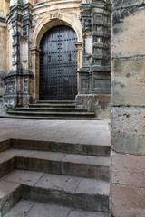 Heavy door of ancient building. Ronda, Andalusia, Spain