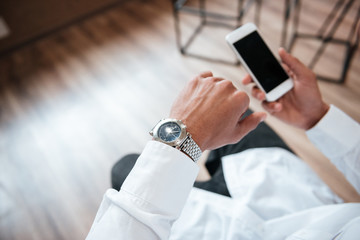 Cropped photo of african handsome businessman look at watch.