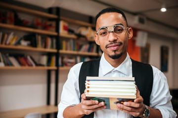 Attractive african businessman holding notebooks