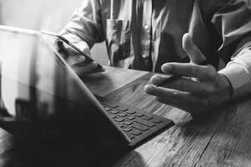 success businessman hand using stylus pen,digital tablet docking
