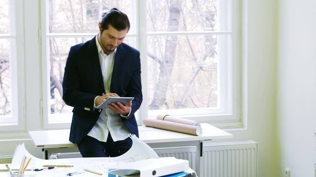Handsome businessman using digital tablet in office 4k