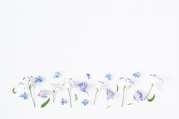 Flowers composition. Border made of lilac and white flowers. Flat lay, top view
