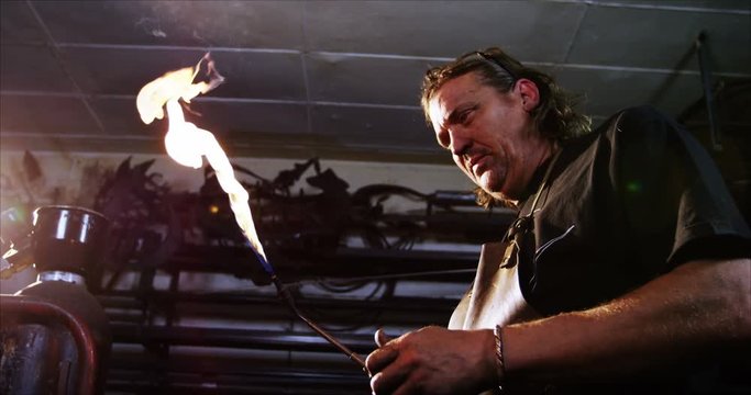 Welder burning welding torch in workshop 4k