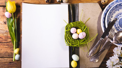 Easter menu on a wooden table decorated in eggs and fresh flower