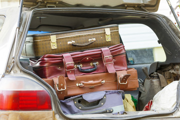 suitcases in the trunk of a car