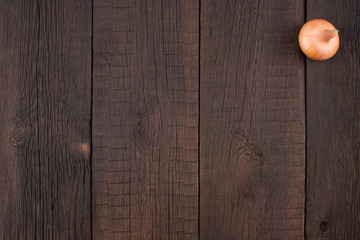 Onion on an old wooden table.